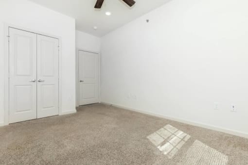 an empty room with white walls and a geometric pattern on the floor