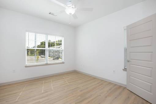 A room with a window and a fan.
