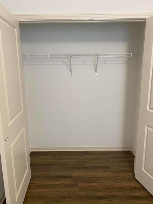 a room with a white wall and a wood floor