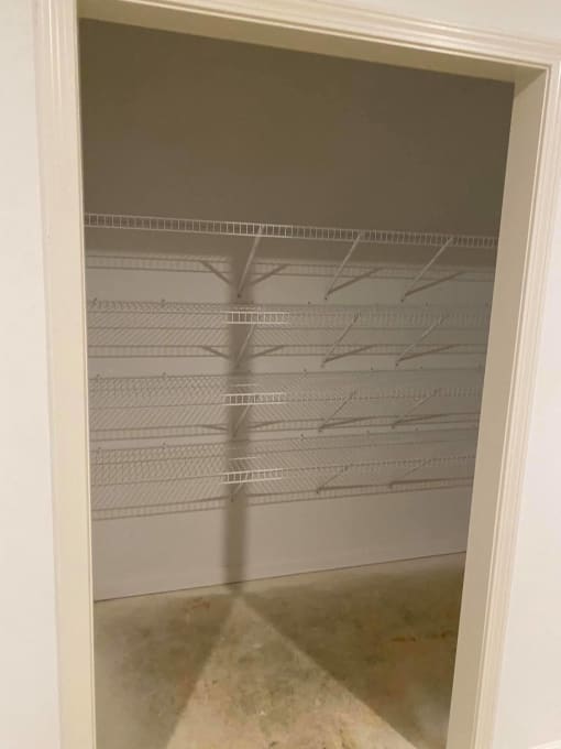 the inside of an empty closet with a mirrored closet door