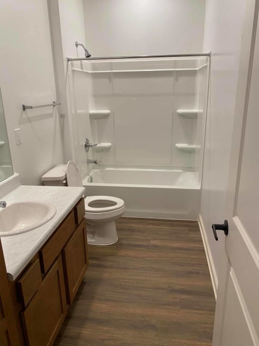 a bathroom with a shower toilet and sink