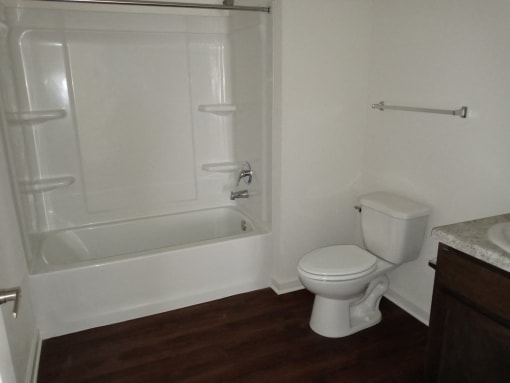 a bathroom with a toilet and a tub and a sink