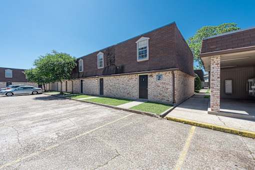 A parking lot with a building on the right.