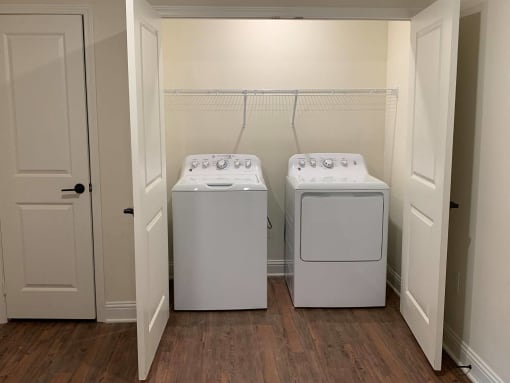 a washer and dryer in a room with white doors