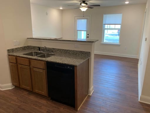 a kitchen with a counter top and a dishwasher