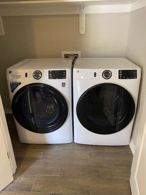 Two front loading washing machines in a laundry room.