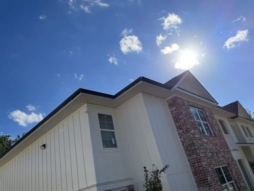 the exterior of a house with the sun shining in the sky