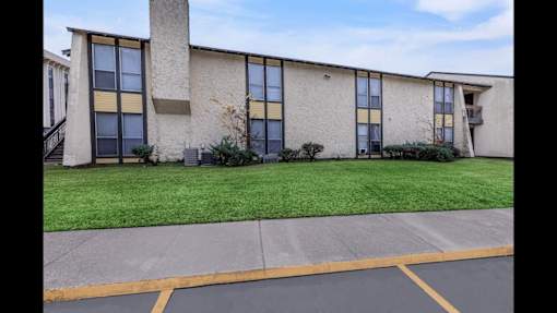 A building with a parking lot in front of it.