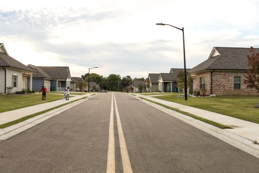 an empty street with houses on both sides of it