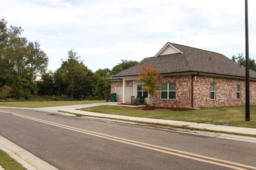 a small brick house on the side of the road