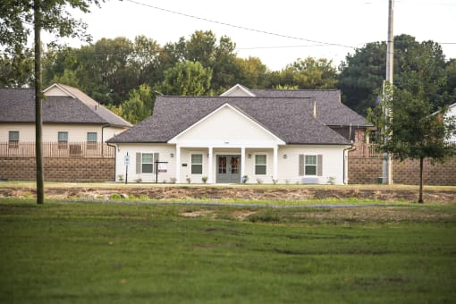 a white house with a yard in front of it