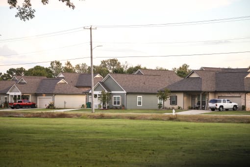 a row of houses on a street in front of a field