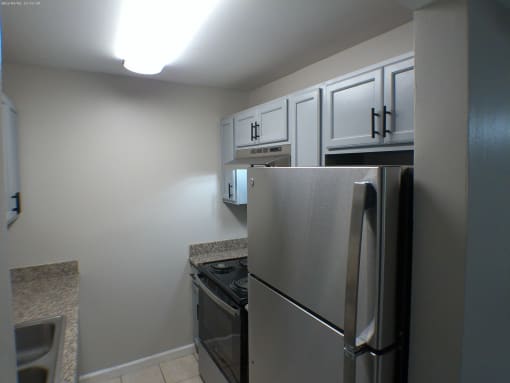 a kitchen with stainless steel appliances and white cabinets