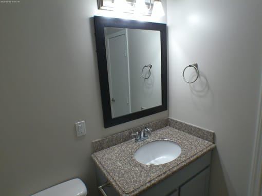 a small bathroom with a sink and a mirror