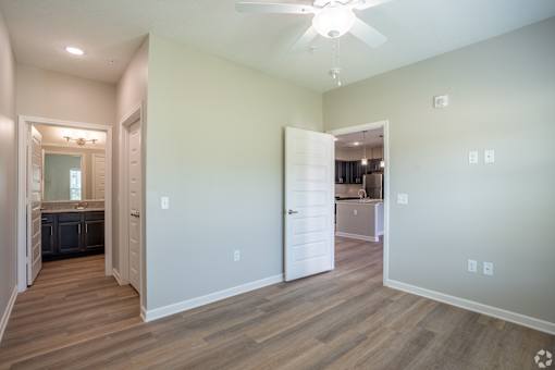 A room with a ceiling fan and lighting fixtures.