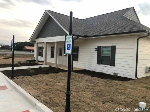 a white house with a handicapped sign in front of it