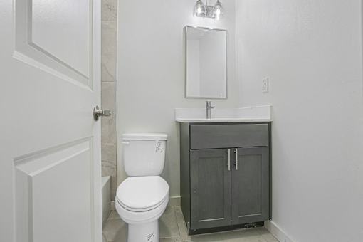 A white toilet sits next to a sink in a bathroom.