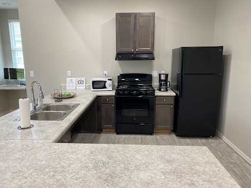 a kitchen with black appliances and a sink and a refrigerator