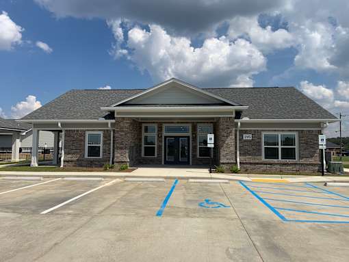 A building with a parking lot in front of it.