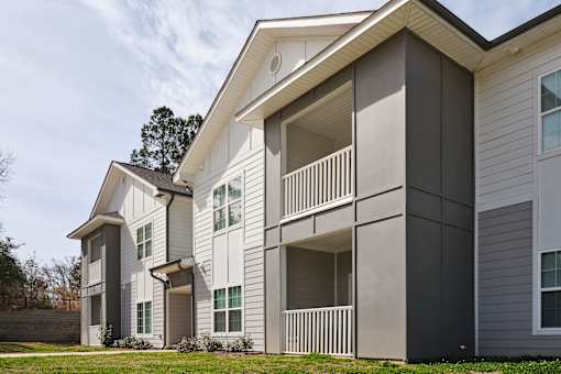 A modern two-story apartment building with balconies.
