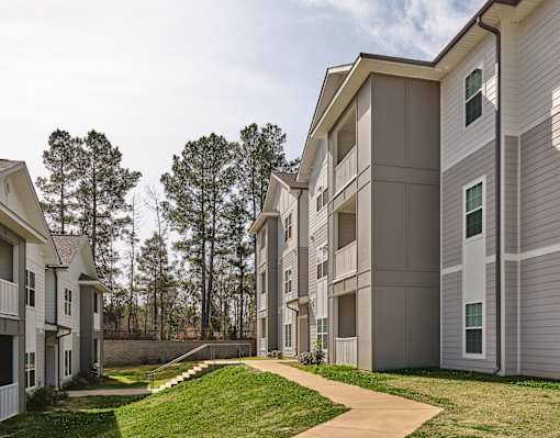 Apartment complex with a walkway in the foreground.