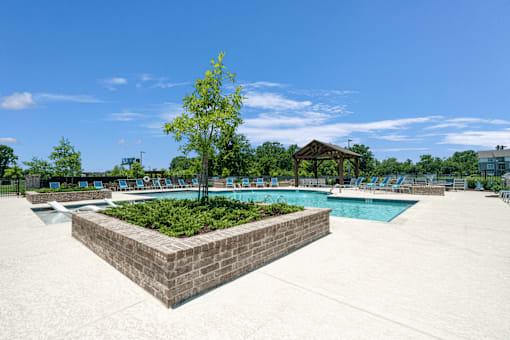 A pool area with a small tree in a planter box at Silver Oaks Apartments, Gonzales, 70737
