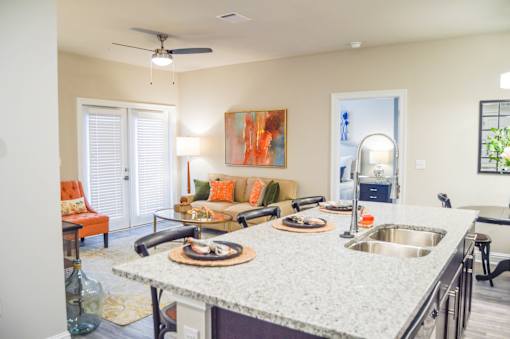 A kitchen with a granite countertop and a painting on the wall at Silver Oaks Apartments, Louisiana 70737