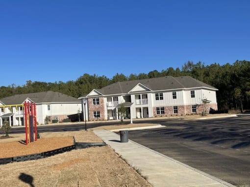 a building with a sidewalk and a street in front of it