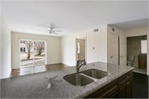 A kitchen with a sink and a ceiling fan.