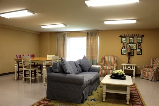 a living room with a couch and a table and chairs