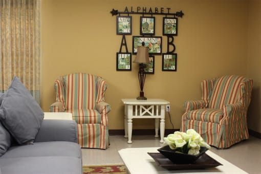 a living room with a couch and chairs and a coffee table