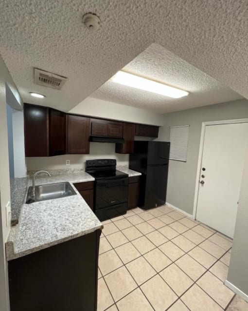 a kitchen with a sink and a stove and