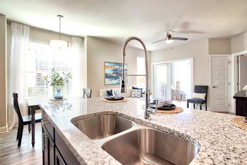 A kitchen with a granite countertop and a stainless steel sink at Silver Oaks Apartments, Gonzales, 70737