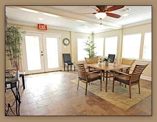 A dining room with a table and chairs.