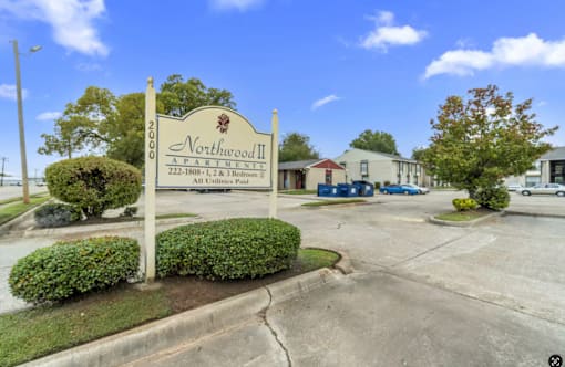 A sign for Northwood II, a 222-bedroom property, stands in front of a building.