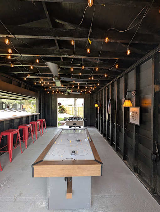 A long table with a bench in the middle of it.
