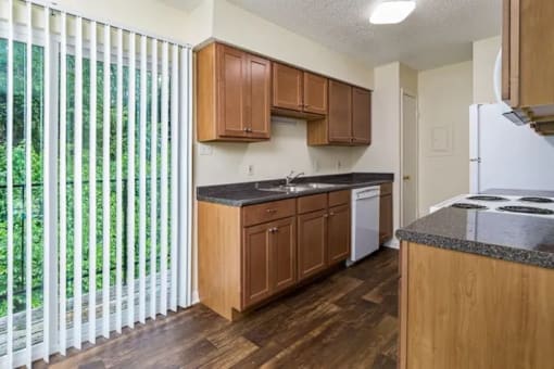 A kitchen with wooden cabinets and a white refrigerator.