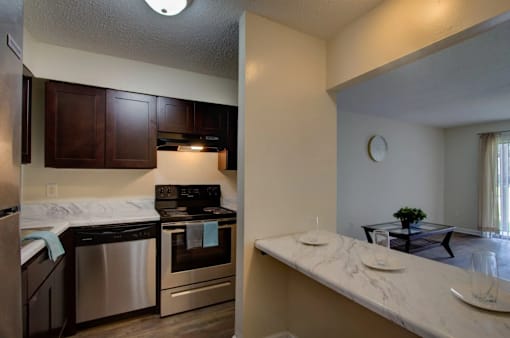 A kitchen with a stove top oven and a dishwasher.