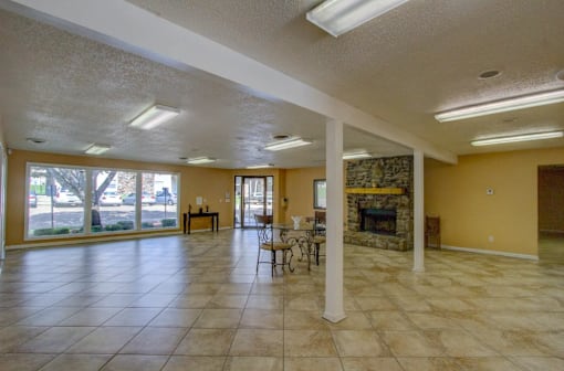 A spacious living room with a fireplace and a dining table.