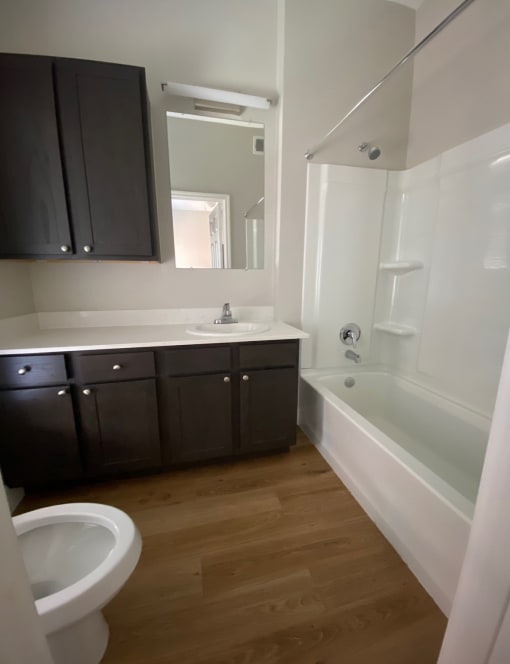 an empty bathroom with a toilet sink and tub