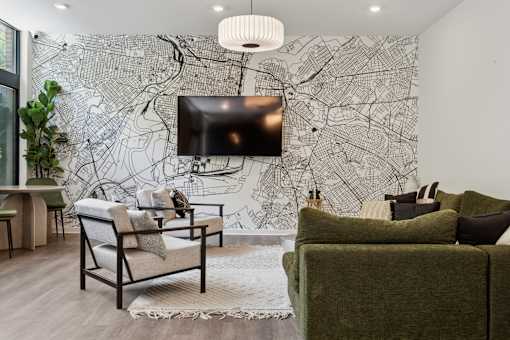 A living room with a large map on the wall and a flat screen TV mounted above it.