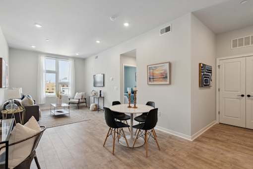 A dining room with a table set for four.