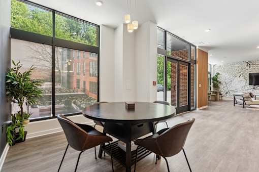 A modern dining room with a large table and chairs.