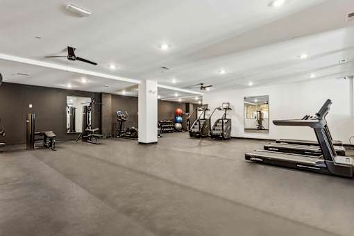 A spacious gym with various exercise equipment.