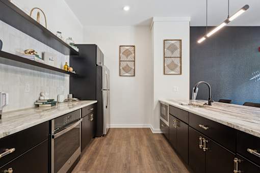 A kitchen with black cabinets and a white counter top.