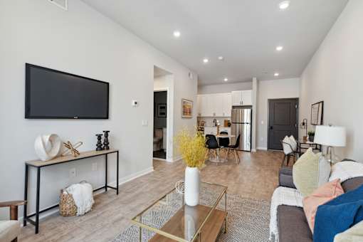 A living room with a couch, a coffee table, and a television.