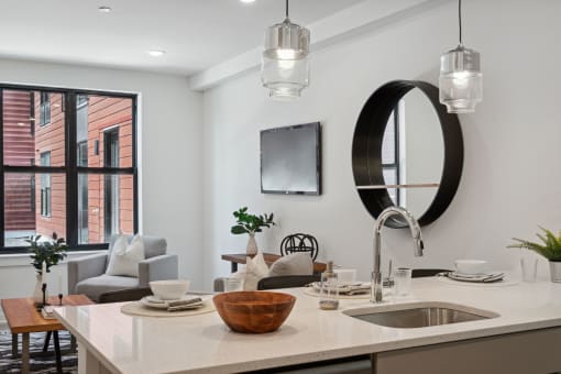 Kitchen and living room with white walls and a large window  at The Anchorage on Kelly, East Falls, PA