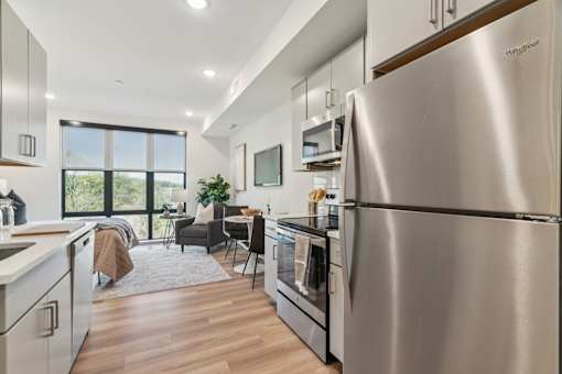 A modern kitchen with a large stainless steel refrigerator.