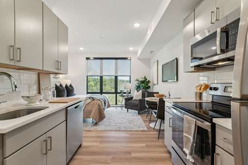 A modern kitchen with a large island and stainless steel appliances.