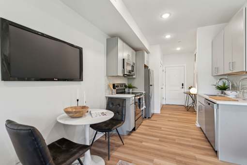 A modern kitchen with a dining table and chairs.